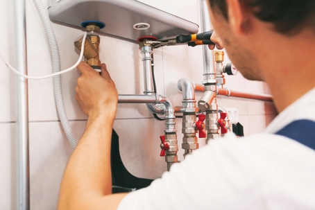 man fixing water heater